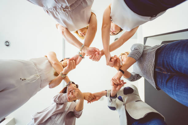 istock Group of women holding hands in circle 931275344