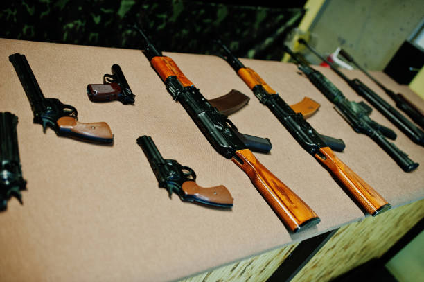 istock Different machine guns and gun revolvers on shooting range. 931282134