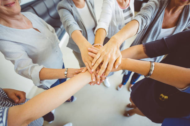 istock Women’s team. Group of women joining hands 931282422