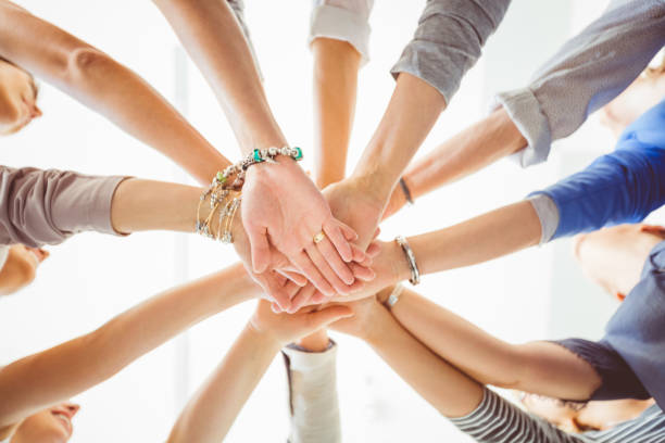 istock Women’s team. Group of women holding hands 931283438