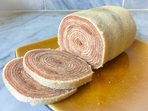 Typical Brazilian Roll Cake on a ceramic dish over a marble counter