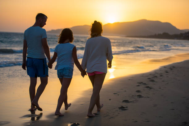 istock Family walking on sea 931289880