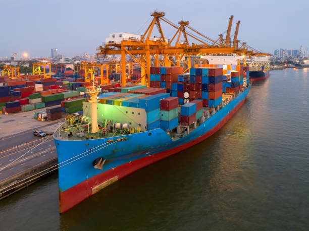 istock Containers yard in port congestion with ship vessels are loading and discharging operations of the transportation in international port.Aerial view of logistics port shot from drone. 931291356