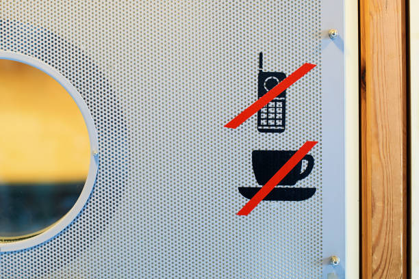 molten sticker with a no smoking sign on the wall with traces of black soot from a fire. non-compliance with fire safety regulations.