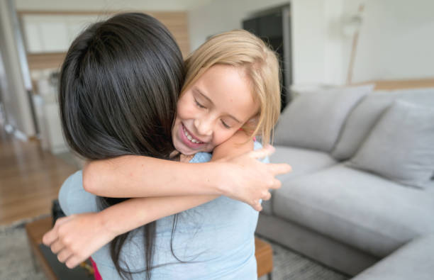 istock Cute little girl hugging her mom with affection and smiling 931297458