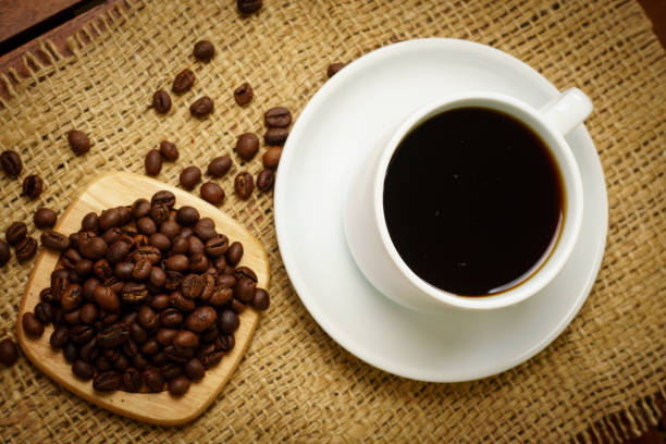istock Cup of hot black coffee and coffee beans on burlap 931301256