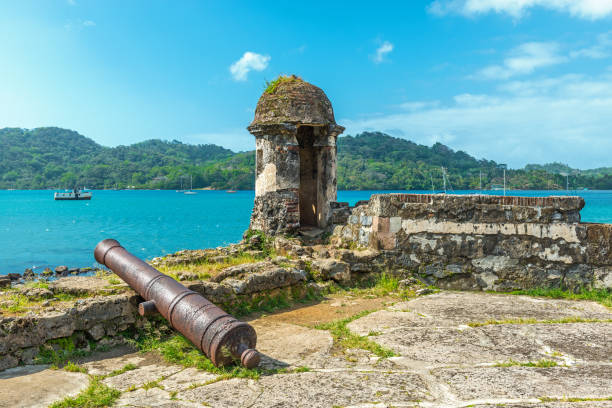 Santiago Fortress in Portobelo Old Spanish cannon at the fortress ruin of Santiago with a view over the Caribbean Sea in Portobelo near Colon, Panama, Central America. colon photos stock pictures, royalty-free photos & images