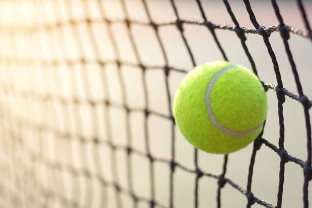 istock Close up tennis ball hitting to net on blur background 931308484