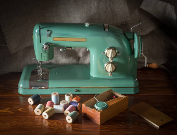 istock an old electric sewing machine with a box with tools and sprinkled coils with threads 931309968