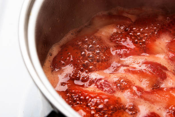 Strawberries boil in a pot