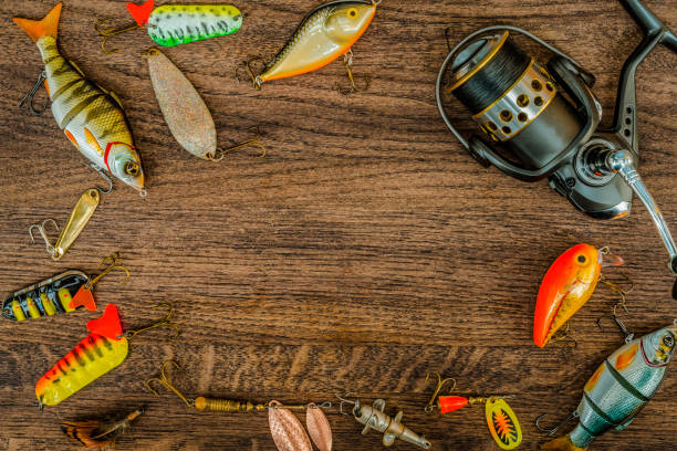 istock Fishing gear on a wooden surface background. 931313564