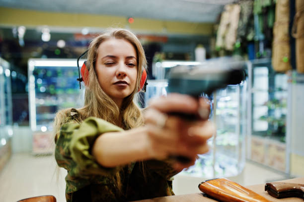 istock Military girl in camouflage on shooting range. 931317312