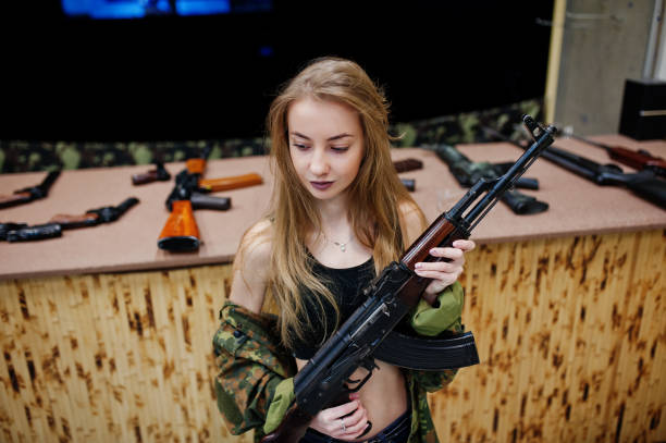 istock Military girl in camouflage on shooting range. 931318174