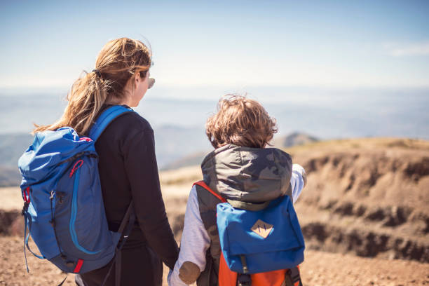 istock Mother and son hiking in mountains 931318404