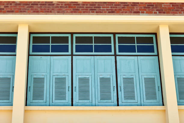 istock Blue vintage wooden windows of brick building 931325322