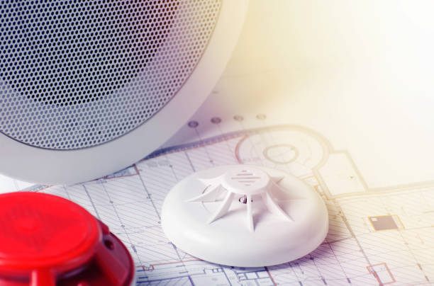 istock Fire security equipment and blueprint on a table. Good for security servise engeniering company site 931325324