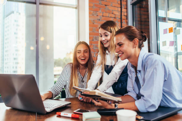 istock Group of students looking at laptop taking a break after studying in college study room 931325776