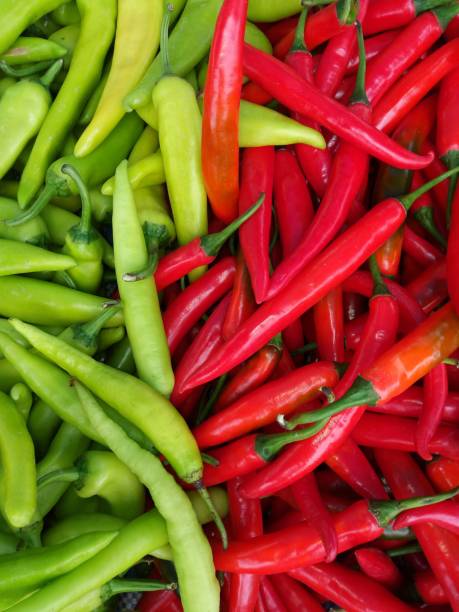 istock Red Green hot chili peppers on white backgrounds 931326314