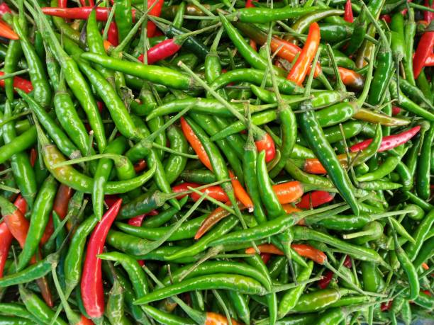 istock Green hot chili peppers on white backgrounds 931326376