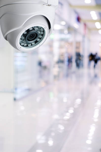 istock Cctv camera security system on a ceiling of a shopping mall blurred background. 931331690