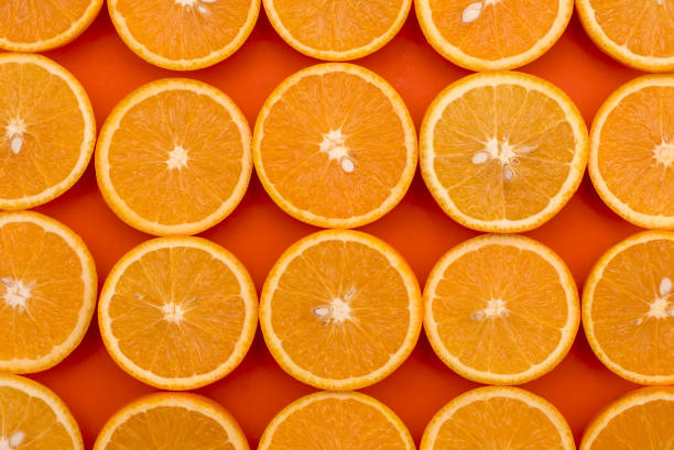 istock Background of half cut oranges on orange background 931338232