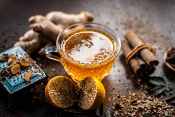 istock Yellow colored lemon ginger tea with all its ingredients in dark Gothic colors.Lemon ginger tea improves the immune system, reduce fever,improve cognition,regulate blood sugar,etc. 931338954