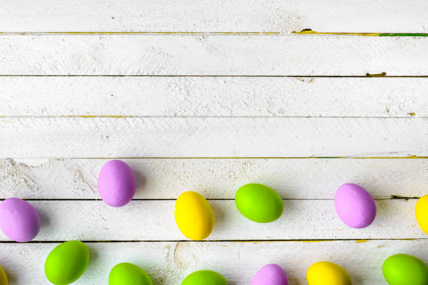 istock Wooden background with easter eggs painted in pastel colors 931339246