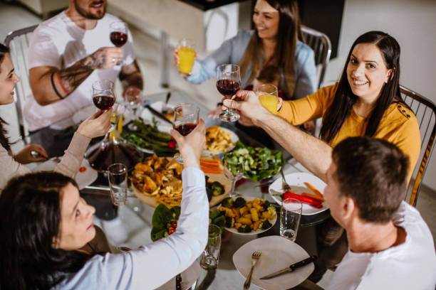 istock Happy family having lunch and cheering 931339830