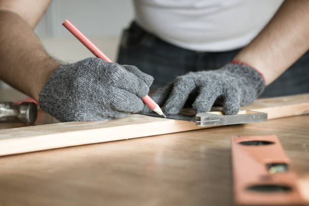 istock carpenter measuring and writing on wood with copy space background 931339974