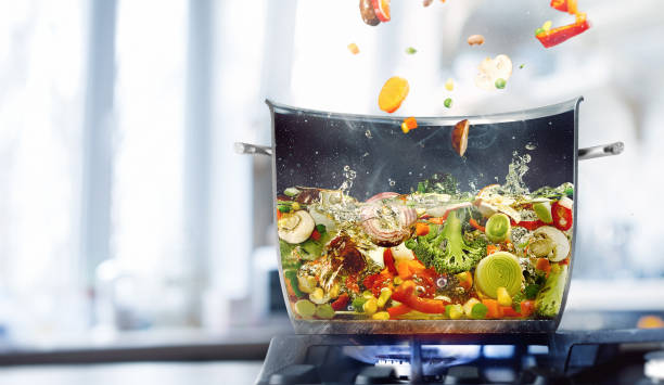 Vegetable broth in a half of saucepan