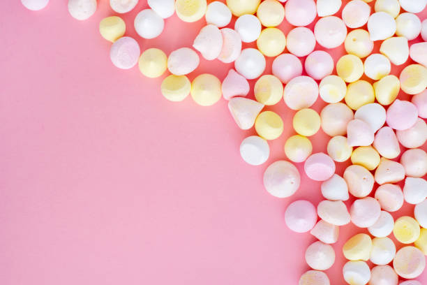 istock multicolored meringue in the corner of a pink background 931351284