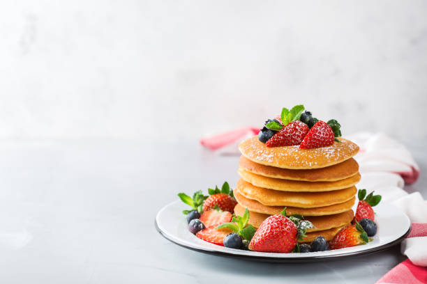 Stack of homemade pancakes for breakfast with berries Food and drink, still life, healthy nutrition concept. Stack of homemade pancakes for breakfast with berries and sugar. Light copy space kitchen background blueberry photos stock pictures, royalty-free photos & images