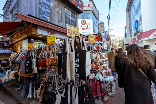 Seoul, South Korea - March 2, 2018 : Local shops - lined at Hongdae (Hongik University) shopping street. Hongdae is a shopping cultural street for young people in Seoul.
