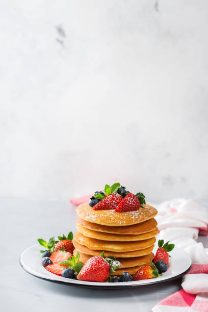 istock Stack of homemade pancakes for breakfast with berries 931352992