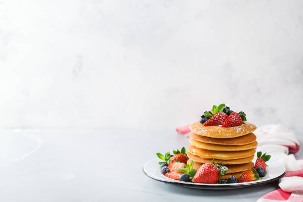 istock Stack of homemade pancakes for breakfast with berries 931353304