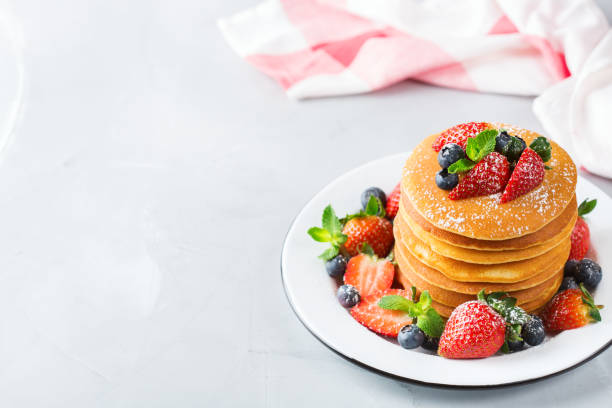 istock Stack of homemade pancakes for breakfast with berries 931356882
