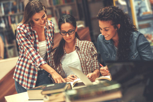 istock Group of female students study in the school library. 931376754