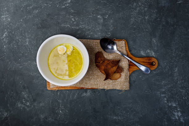 istock Chicken broth with homemade noodles, bread and quail eggs. 931384930