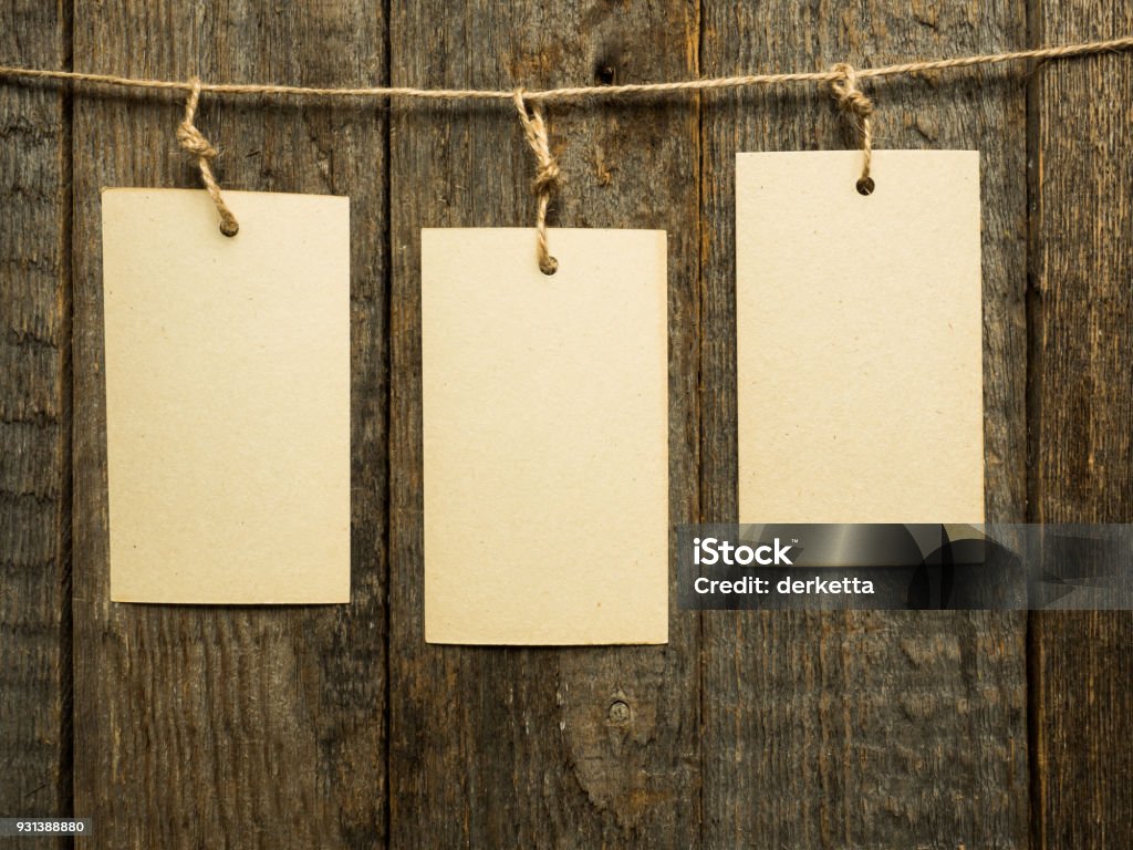 Paper notes on rope on wooden background. Copy space Paper notes on rope on wooden background. Copy space. Adhesive Note Stock Photo