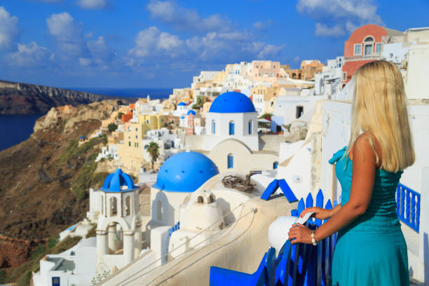 istock Blond woman enjoying vacations in Santorini 931389400