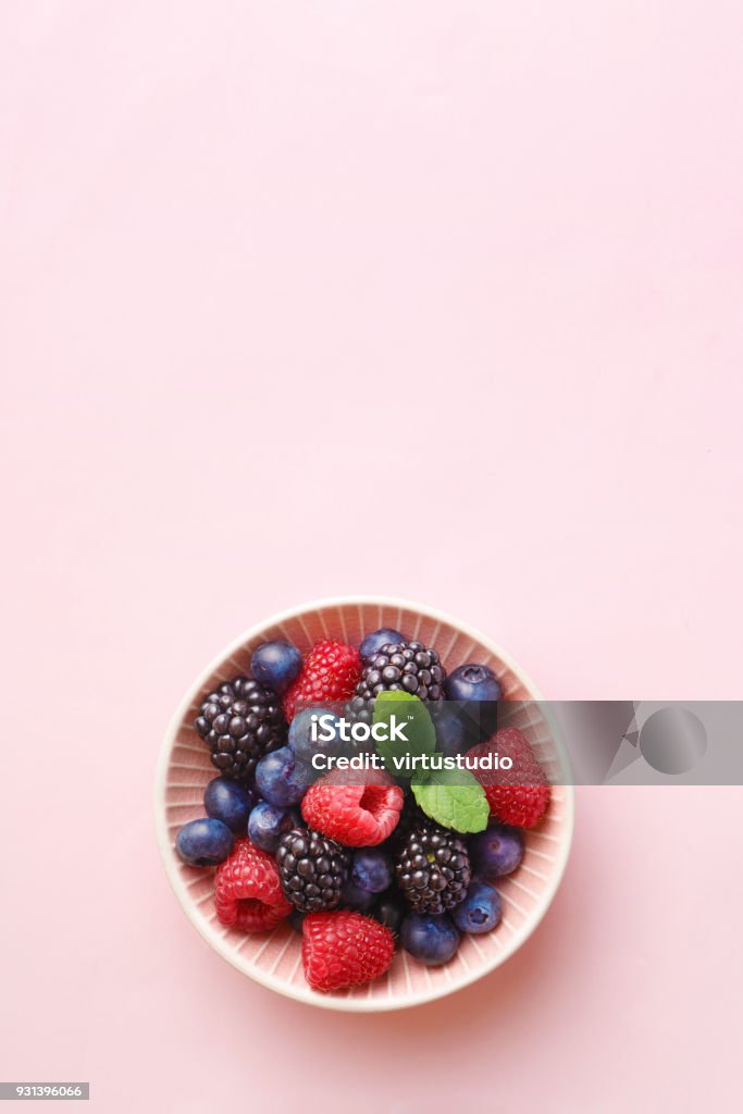 Bol de fruits de baies (framboises, bleuets, blackberry) sur un fond pastel. Vue de dessus. Espace copie - Photo de Baie - Partie d'une plante libre de droits