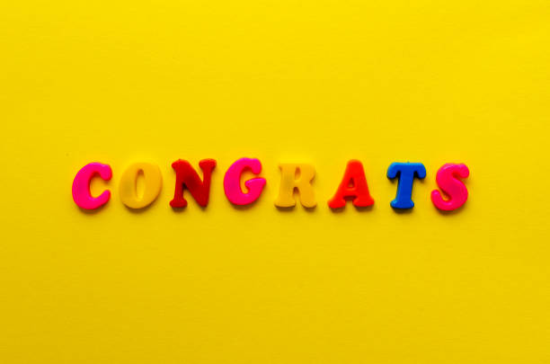 istock word 'congrats' from magnetic letters on yellow paper background 931400682