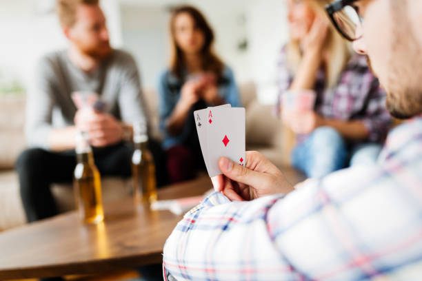 istock Group of friends having fun while playing cards 931403398