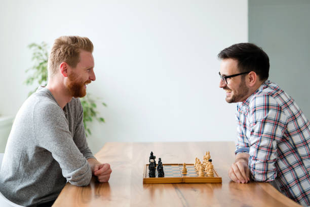 istock Portrait of two young man playing chess 931404760