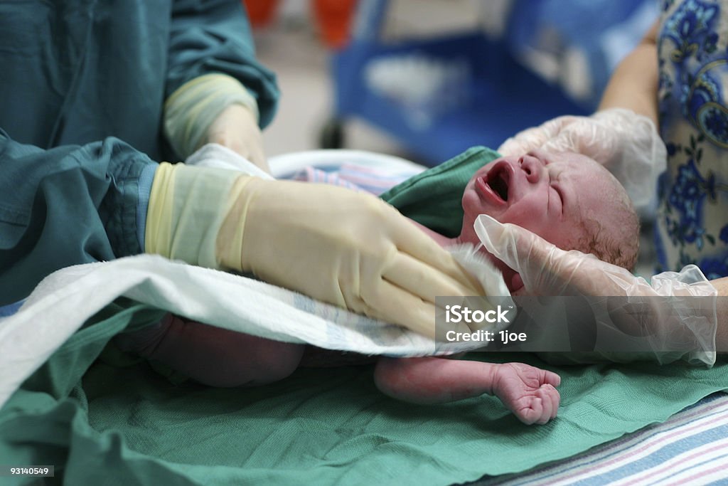 Born a newborn baby being cared for Labor - Childbirth Stock Photo