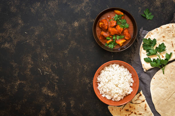 istock Indian dish Chicken Tikka masala with rice. Top view, copy space. 931407378