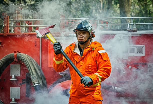 istock Emergency Fire Rescue training, firefighters in uniform, arm with a fire axe 931407998