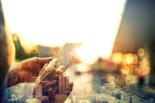 istock Double exposure of Wwoman using her mobile phone in the city 931408552