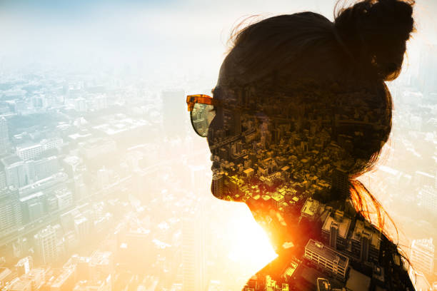 Contemplation Young woman wearing sunglasses at sunset is looking at the vast megapolis. Double exposure photography sun exposure stock pictures, royalty-free photos & images