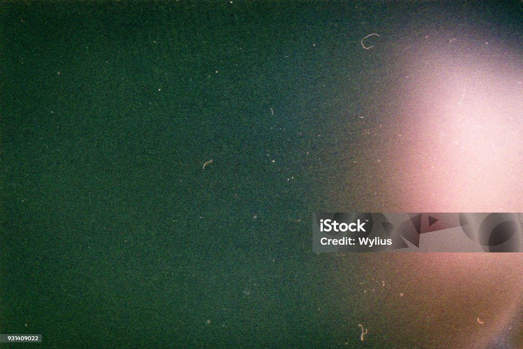 Designed film background Designed film background with heavy grain, dust and light leak Textured Stock Photo